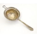A silver tea strainer hallmarked London 1945 maker Wakely & Wheeler 1/2" long Please Note - we do