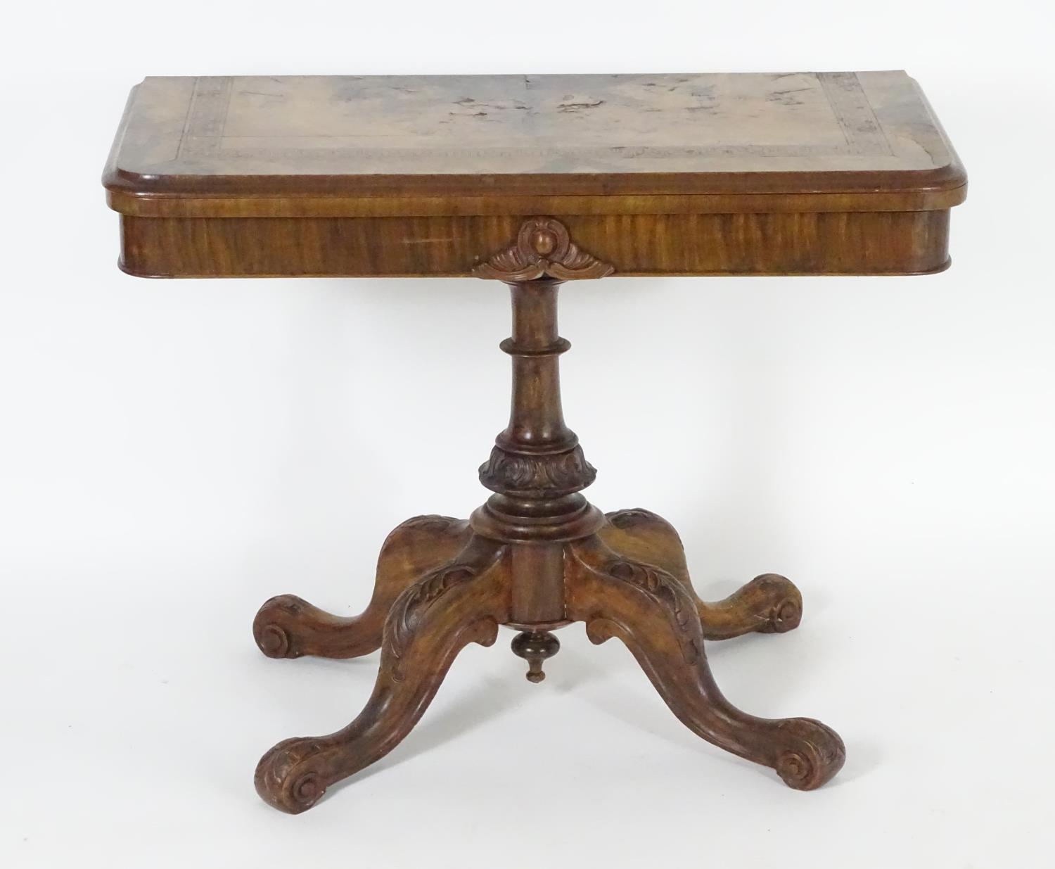 A late 19thC walnut card table with a rectangular top above Greek key decoration and a turned