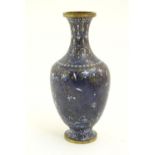 A Chinese cloisonne vase, the lapis blue ground with scrolling floral and foliate details. Approx. 9