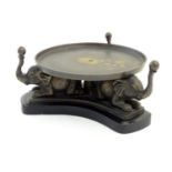 A 20thC circular stand with a triform base with cast elephant supports. Approx. 4 1/4" high Please