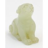 An Oriental jade model of a seated dog with incised features. Approx. 1 3/4" high Please Note - we