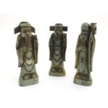 Three Oriental carved soapstone figures modelled as scholars. Approx. 8 1/4" high (3) Please