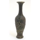 A Chinese cast vase decorated with a landscape scene with crane bird detail in relief. Impressed
