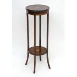 An early 20thC mahogany jardinière stand with satinwood marquetry detailing and four shaped