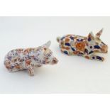 Two Oriental models of pigs decorated in the Imari palette with floral and foliate detail. Character