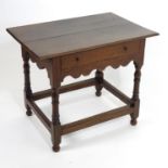 An early 18thC oak side table with a rectangular top above a single frieze drawer and shaped