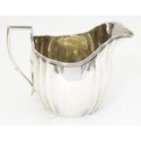 A silver cream jug , hallmarked London 1908 maker C S Harris & Sons Ltd. 4" high Please Note - we do