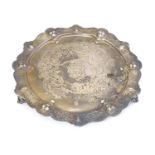 A silver salver with engraved detail and armorial to centre. Hallmarked Sheffield 1857 maker