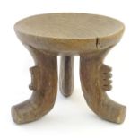 Ethnographic / Native / Tribal: A three legged African stool with dished top. Approx. 14" high x 15"