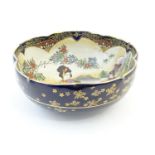A Japanese bowl with a lobed edge, decorated with Geisha girls in a landscape with mount Fuji
