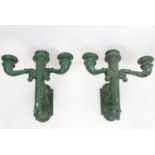 A pair of cast metal exterior light fittings, formed as torches with green painted finish and