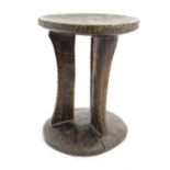 Ethnographic / Native / Tribal: A carved African stool with circular top and base. Approx. 12"