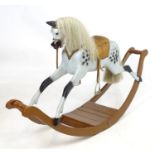 Toy: A late 19th / early 20thC dapple grey rocking horse with horse hair mane and tail, on bow