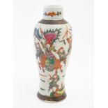 A Japanese crackle glaze vase decorated in famille verte with warriors and horses. Character marks