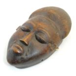 Ethnographic / Native / Tribal: A carved African mask. Approx. 12" long Please Note - we do not make