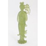 A Chinese carved jade figure modelled as a female figure with a lotus flower, possibly Guan Yin.