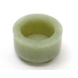 A small Chinese jade brush pot of cylindrical form raised on four feet. Approx. 1 1/2" Please Note -