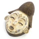 Ethnographic / Native / Tribal: A carved African mask with white painted detail. Approx. 12" high
