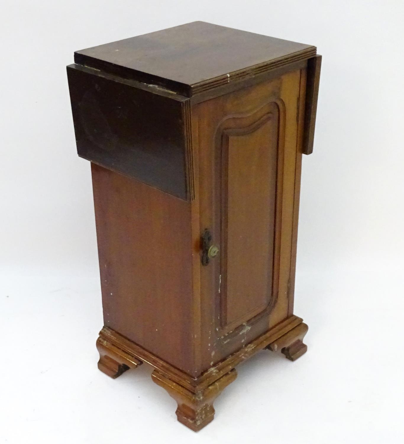 A mahogany bedside / pot cupboard with drop flap top Please Note - we do not make reference to the