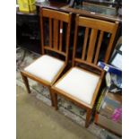 A pair Arts & Crafts oak dining chairs with upholstered seats. Stamped under with registration no.
