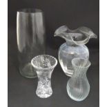 Four glass vases, to include a lead crystal example and an acid etched example. The largest 12 1/