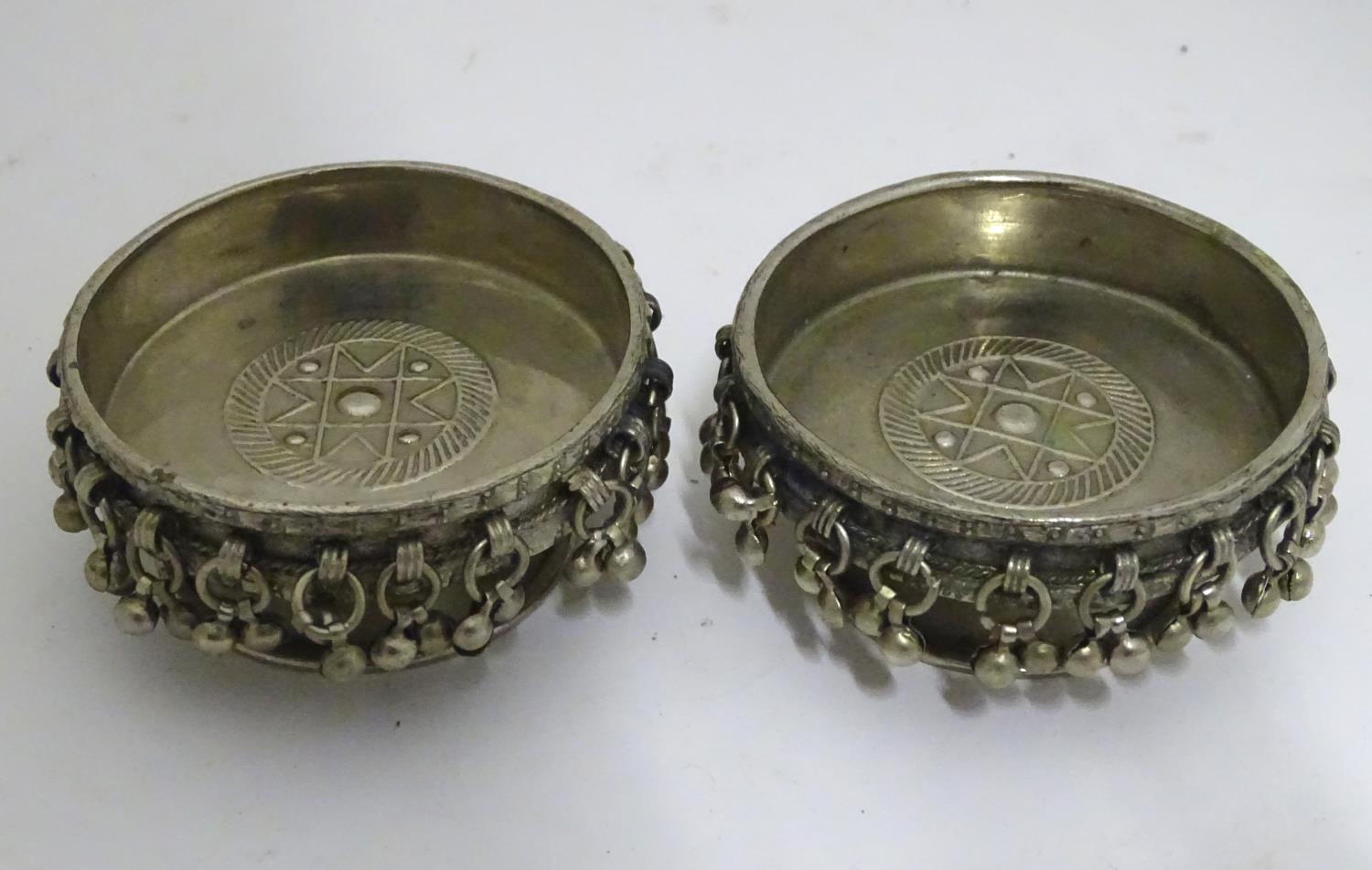 A pair of Middle Eastern white metal candle stands Please Note - we do not make reference to the