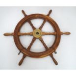 A teak and brass ships wheel Please Note - we do not make reference to the condition of lots