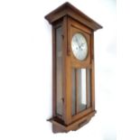 A 20thC English wall clock Please Note - we do not make reference to the condition of lots within