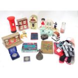A box of miscellaneous items to include dolls house furniture, ceramic money box, book ends, etc.