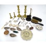 A quantity of assorted metal ware to include a pair of brass candlesticks, silver plated knife