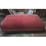 A large upholstered footstool on castors Please Note - we do not make reference to the condition