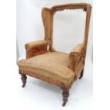 A late 19th / early 20thC wingback armchair Please Note - we do not make reference to the