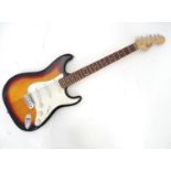 A Squier Fender stratocaster electric guitar and case Please Note - we do not make reference to
