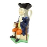 A large Toby jug formed as a seated gentleman in a tricorn hat with a tankard of ale. Approx. 10 3/