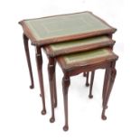 A nest of three mahogany tables with tooled leather tops and inset glass (3) Please Note - we do not