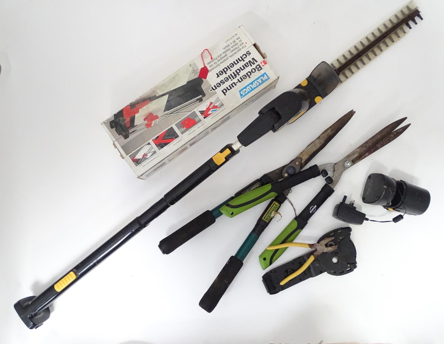 A quantity of assorted tools to include tile cutter, Gtech hedge trimmer, etc Please Note - we do