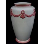 A large ceramic vase of ovoid form with pink scroll decoration, labelled under George MacDonald.