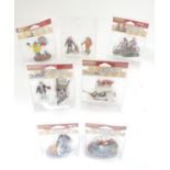 A quantity of assorted figurines, some with dogs, to include a clown, people riding bikes, a skier