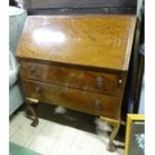 A 20thC mahogany bureau on ball and claw feet. Approx. 40" high Please Note - we do not make