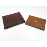 Two wooden cutlery boxes, with assorted contents to include leather items, wallets, brasses, costume