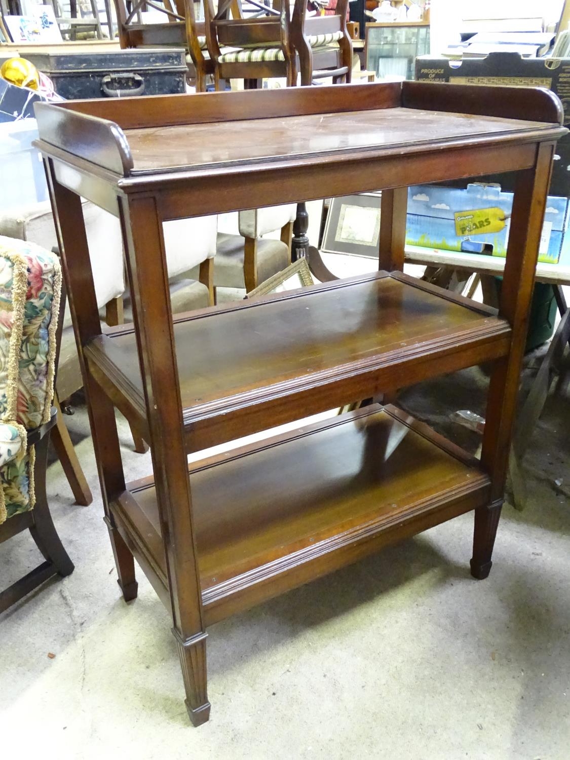 A 20thC mahogany 3 tier buffet. Approx. 45 3/4" tall Please Note - we do not make reference to the