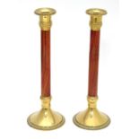 A pair of walnut and brass candlesticks Please Note - we do not make reference to the condition of