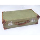 An early 20thC canvas and leather suitcase Please Note - we do not make reference to the condition