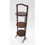 A mahogany folding cake stand with three tiers Please Note - we do not make reference to the