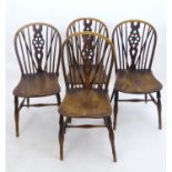 Four yew and elm wheelback dining chairs (4) Please Note - we do not make reference to the condition