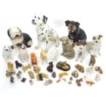 A quantity of dog figurines, to include some ceramics examples Please Note - we do not make