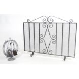 A 20thC wrought iron spark guard / fire screen with scrolling detail. Together with a small