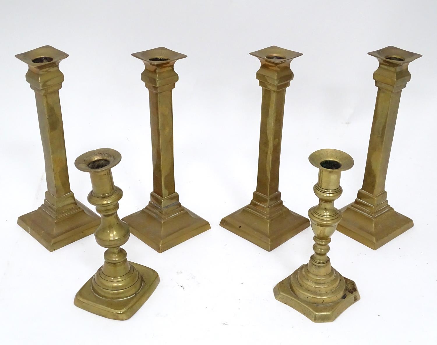 Four matching brass candlesticks, together with a pair of brass candlesticks (4+2) Please Note -