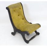 A reproduction ebonised child's slipper chair Please Note - we do not make reference to the