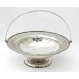 A silver plated cake basket with swing handle Please Note - we do not make reference to the